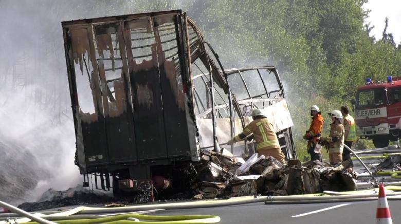 18 killed as tour bus bursts into flames after collision