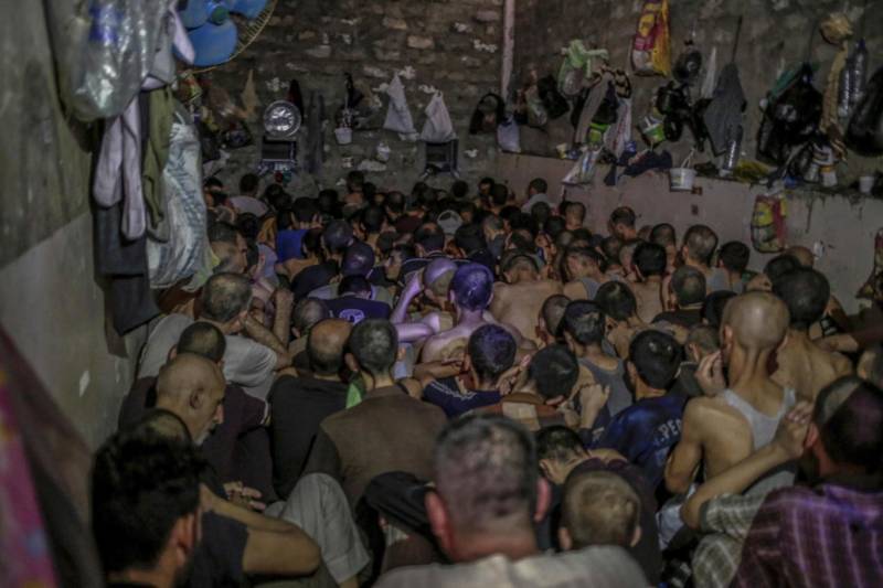 Shocking photos of suspected Isis fighters held like battery chickens in overcrowded prison