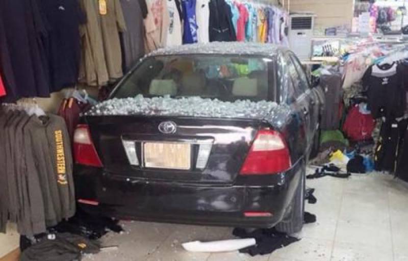 Woman rams car into dress shop